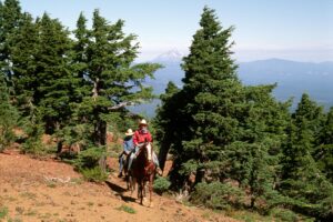 a couple of people on a multi day horseback trail ride with soda peak outfitters